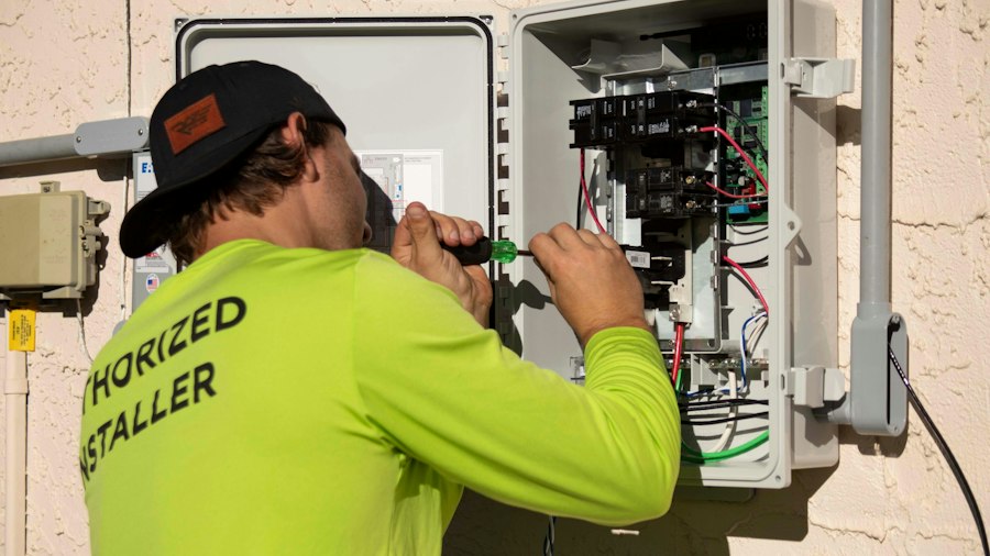 Electrician wiring an outdoor panel